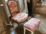 a chair and a foot stool in a room