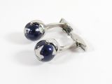 pair of cufflinks with blue glass balls on a white background