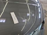 a sticker on the hood of a car that has a price tag attached to it