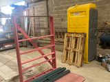 a red and yellow pallet sitting in the middle of a warehouse