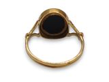 an image of a gold ring with a black stone in the center
