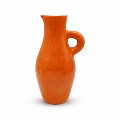 an orange vase with a curved handle on a white background
