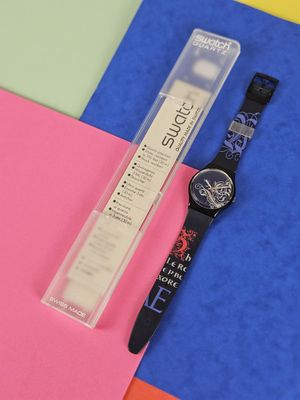 a watch sitting next to a ruler on a piece of paper