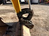 a close up view of a yellow excavator on the ground