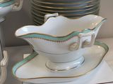 a white and blue bowl and saucer sitting on a table