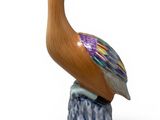 a figurine of a bird sitting on top of a rock