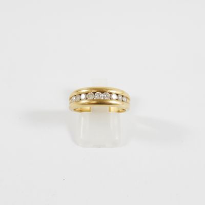 a yellow gold ring with diamonds on a white background