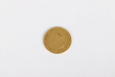 a gold coin on a white surface with a white background