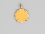 a close up of a gold coin with a woman ' s face on it
