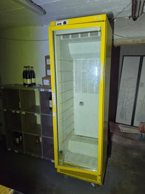 a yellow refrigerator in the middle of a room