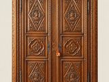 a wooden armoire with carvings and carvings on the doors