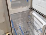 a white refrigerator with a door open in a room