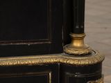 a black and gold cabinet with a clock on it