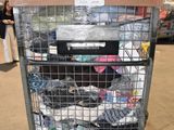 a metal cart with many items in it in a warehouse