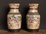 two vases that are sitting on a table