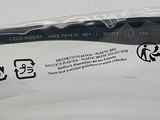 a toothbrush that is wrapped in plastic on a white surface