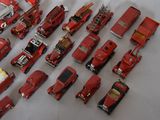 a lot of toy fire trucks and trucks on the table