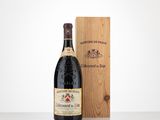 a bottle of wine sitting next to a wooden box