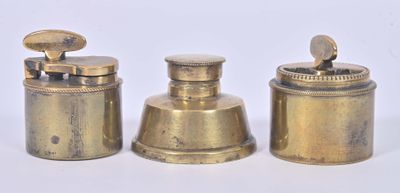 three antique brass containers with lids on a white surface