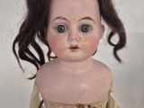 a close up of a doll with a very long hair