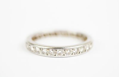 a close up of a diamond ring on a white surface