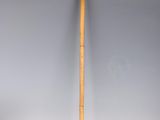 an old cane with a wooden handle sitting on top of a white surface