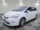 the white toyota prius is parked on a checkered tile floor