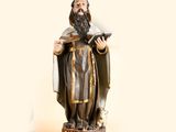 a statue of a man with a beard holding a book