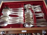 a lot of silver spoons and spoons in a box