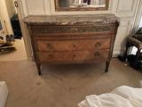 a dresser with a marble top in a room