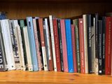 a book shelf with many books on it in a room