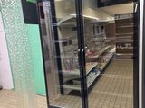 an image of a refrigerator in a store with glass doors