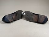 pair of women ' s shoes on a white surface with a white background