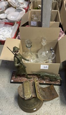 a box full of glass bottles and a statue of a soldier