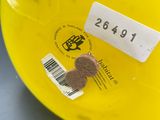 a yellow frisbee with a brown heart on it