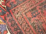 a close up of a red and blue rug on the floor