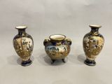 three vases sitting side by side on a white surface