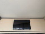 a flat screen tv mounted on the wall above a fireplace