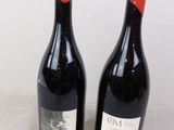 two bottles of wine sitting next to each other on a table