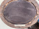 a picture of a round wooden table with a blackboard on it