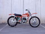 a red dirt bike parked in a parking lot