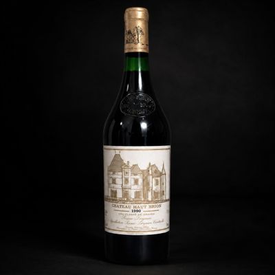 a bottle of wine sitting on top of a black table