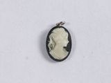 a black and white cameo pendant with a woman ' s profile