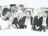two black and white photos of a group of people standing together