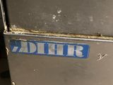 a picture of a dirty refrigerator in a dirty kitchen