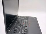 a black laptop with a red button on the keyboard