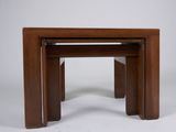a set of three wooden nesting tables on a white background