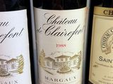three bottles of wine are lined up on a table