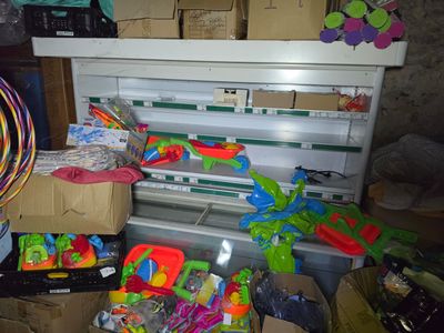 a refrigerator filled with lots of toys in a room