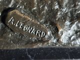 a close up of a statue of a person with a name on it